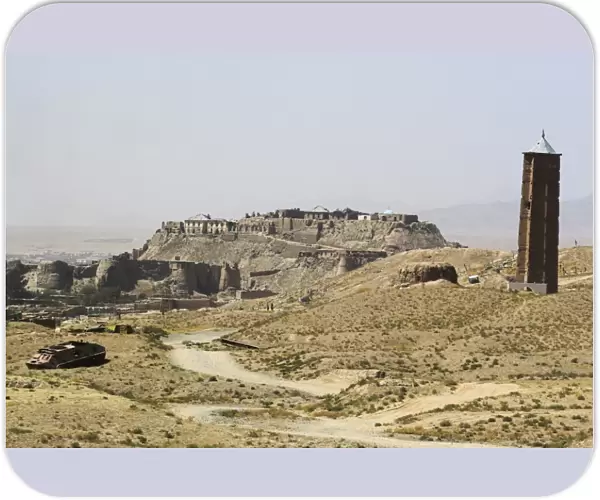 Military graveyard and one of two 12th century minarets that served as models for the Minaret of Jam, with ancient city walls and Citadel in the background, Ghazni