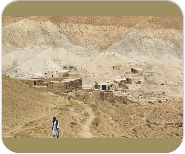 Man walking up mountain road, between Herat and Maimana, after Subzak Pass