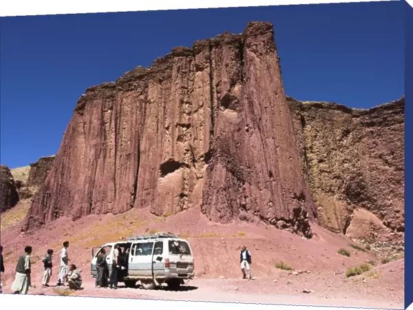 Tourist and locals at the Magenta cliffs near Shahr-e-Zohak (Red City)
