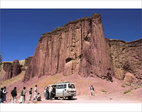 Tourist and locals at the Magenta cliffs near Shahr-e-Zohak (Red City)