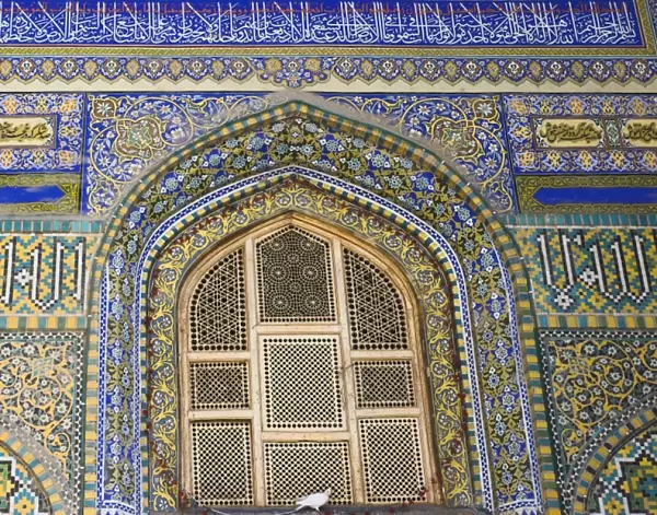 Famous white pigeon sits below window, Shrine of Hazrat Ali, who was assassinated in 661