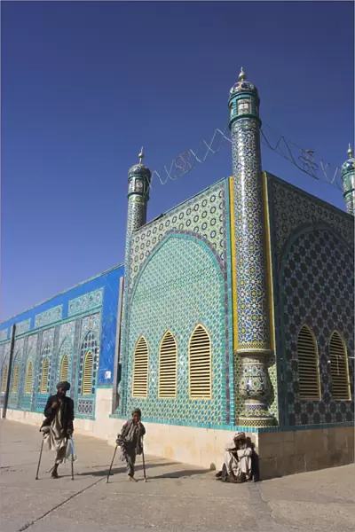 Father and son amputees outside the Shrine of Hazrat Ali, who was assassinated in 661