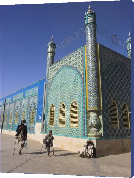 Father and son amputees outside the Shrine of Hazrat Ali, who was assassinated in 661