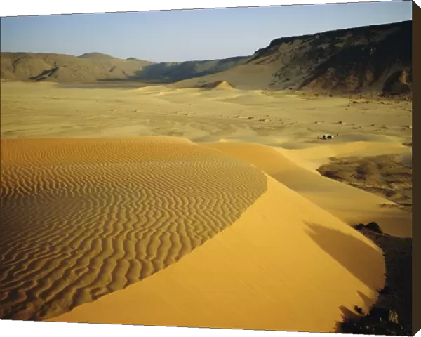 Dunes in canyon near Amguid, vehicle in the distance, Algeria, North Africa