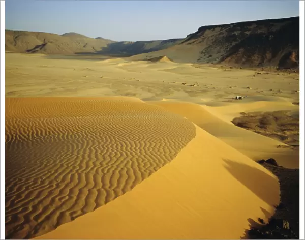 Dunes in canyon near Amguid, vehicle in the distance, Algeria, North Africa