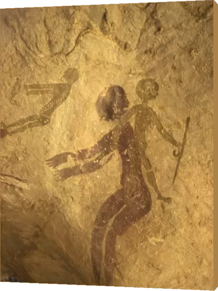 Rock paintings of decorated woman and children on cave, Tassili n Ajjer