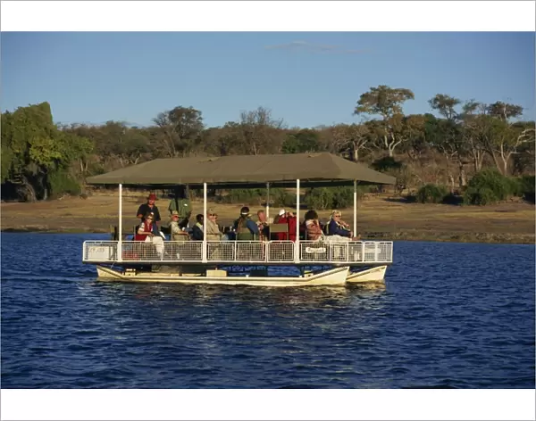 Tourists game viewing on boat on the Chobe River, Chobe National Park, Botswana, Africa