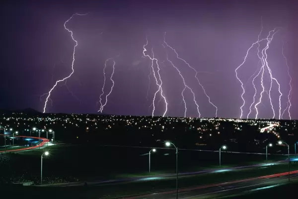 Fork lightning at night over a city