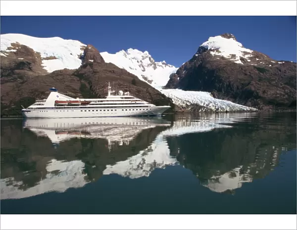 Reflections of the Seabourn Pride cruise ship, mountains and glacier in Chilean Fjordland