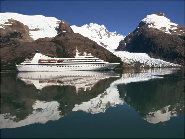 Reflections of the Seabourn Pride cruise ship, mountains and glacier in Chilean Fjordland