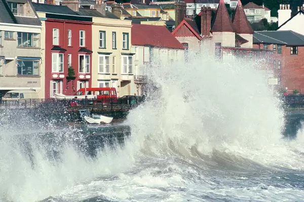 Waves pounding sea wall and rail track in storm, Dawlish, Devon, England