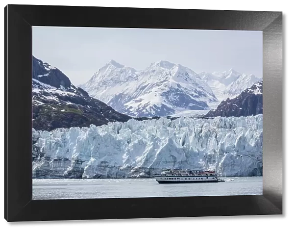 A tourist ship explores the Lamplugh Glacier in Glacier Bay National Park and Preserve
