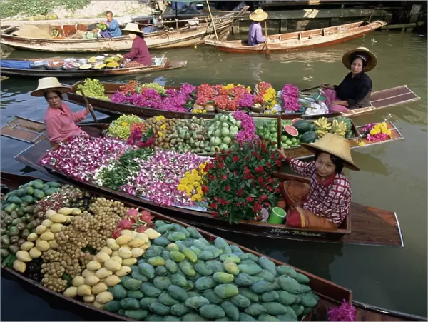 Market traders in boats selling flowers and fruit