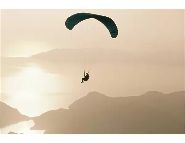 Man paragliding over the Mediterranean coast