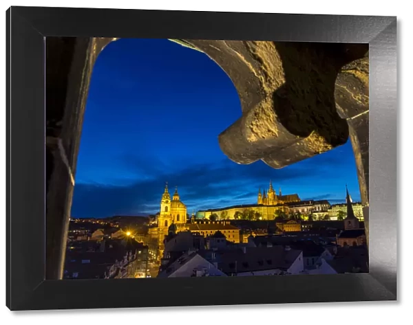 View from the Lesser Town Bridge Tower to Prague Castle and St. Nicholas Church at dusk