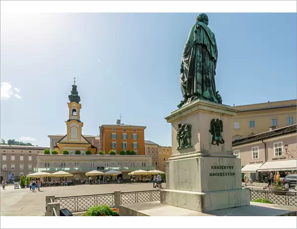 View of St. Michaelskirche and Mozart Statue in Residenzplatz, Salzburg, Austria, Europe