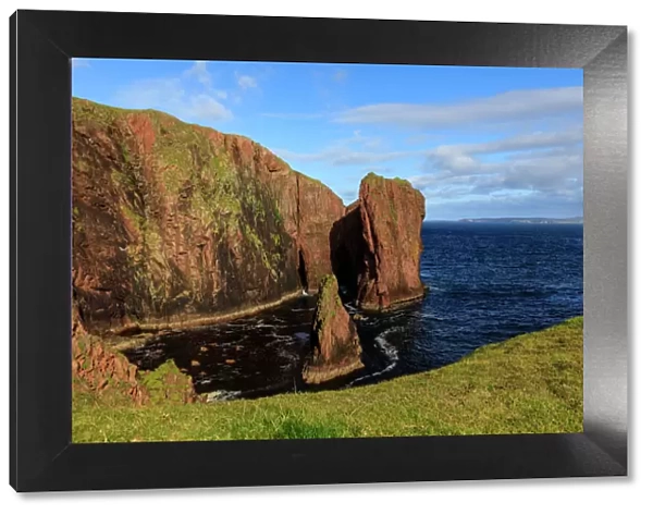 North Ham, lichen covered huge red granite cliffs and stacks, Muckle Roe Island, Shetland