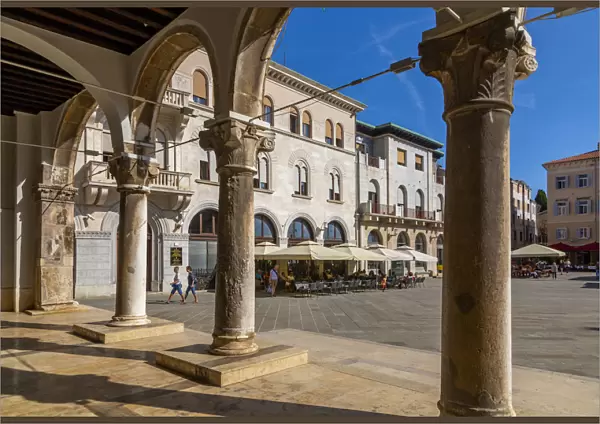 View of cafes from arches of the Town Hall in Forum Square, Pula, Istria County, Croatia