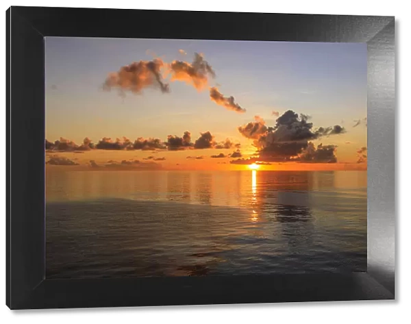 Sunset over beautiful calm sea, interesting clouds, vibrant colours, St. Kitts, St