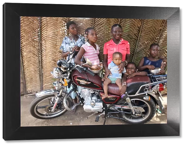 Family around a motocycle, Lome, Togo, West Africa, Africa
