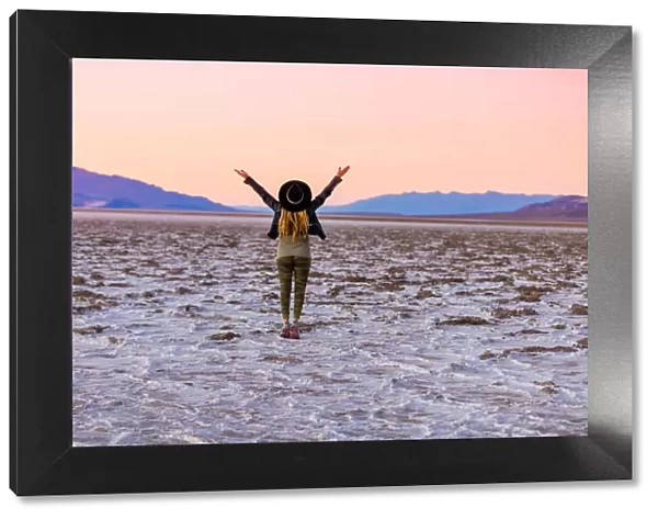 Model posing for the camera at sunset over the salt flats of the Mesquite Dunes
