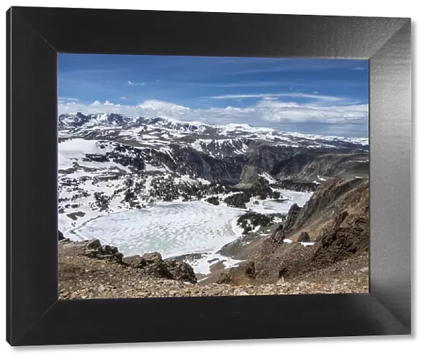 Snow-capped mountains and a frozen lake near Beartooth Pass, Wyoming