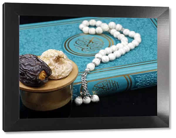 Holy Quran book with prayer beads and date, Ramadan concept, Muslim faith and religion