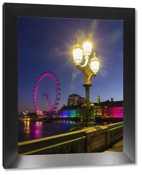 Lamp on Westminster Bridge with London Eye and London Aquarium in background at sunrise, London, England, United Kingdom, Europe