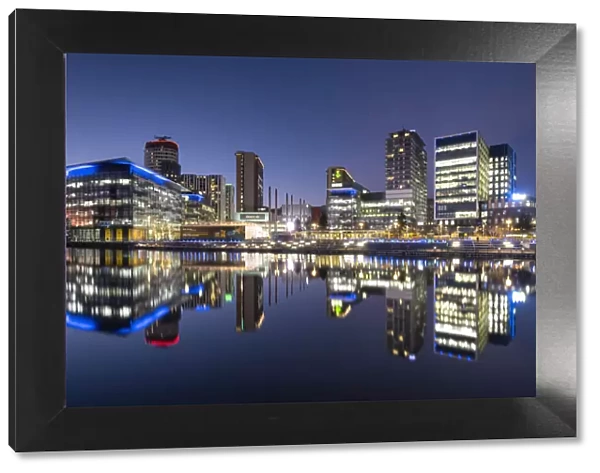 MediaCityUK reflected in North Bay at night, Salford Quays, Salford, Manchester, England, United Kingdom, Europe