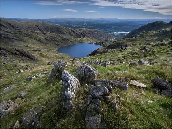 Walkers on Little How Crags above Levers Water on The Old Man of Coniston, Lake District National Park, UNESCO World Heritage Site, Cumbria, England, United Kingdom, Europe