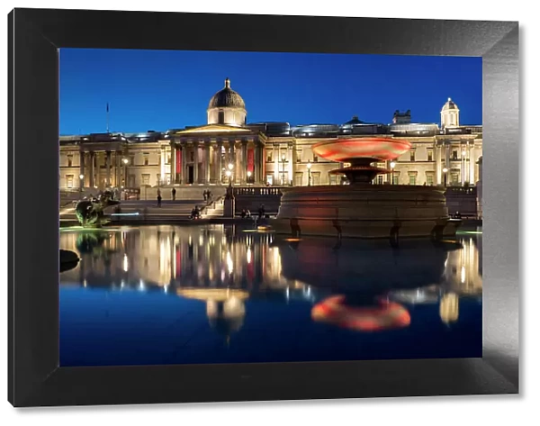 Trafalgar Square and National Gallery at dusk reflected in fountain, London, England, United Kingdom, Europe