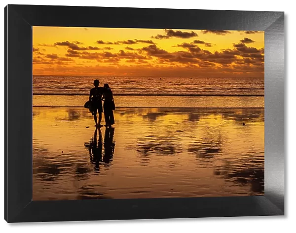 View of couple at sunset on Kuta Beach, Kuta, Bali, Indonesia, South East Asia, Asia