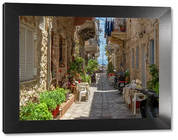 View of narrow street leading towards harbour in Kalimnos, Kalimnos, Dodecanese Islands, Greek Islands, Greece, Europe