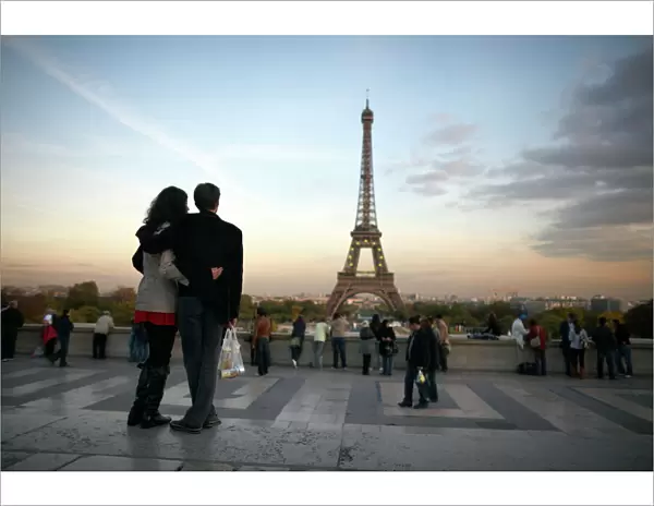 A couple look towards the Eiffel Tower, Paris, France, Europe