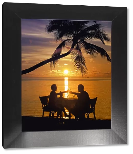Couple having dinner at the beach, toasting glasses, Maldives, Indian Ocean, Asia