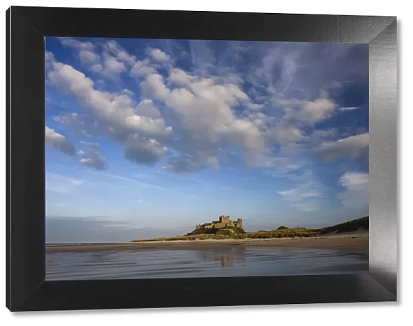 Bamburgh Castle bathed in evening light, viewed from Bamburgh Beach, Bamburgh