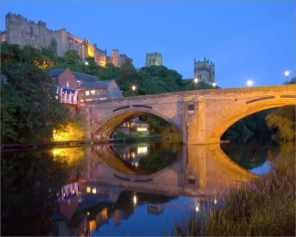 View to the illuminated castle and cathedral across the River Wear below Framwellgate Bridge