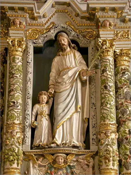 Retable in the Rosary detail dating from the 17th century showing St. Joseph and child, Guimiliau parish church enclosure, Guimiliau, Finistere, Brittany, France, Europe