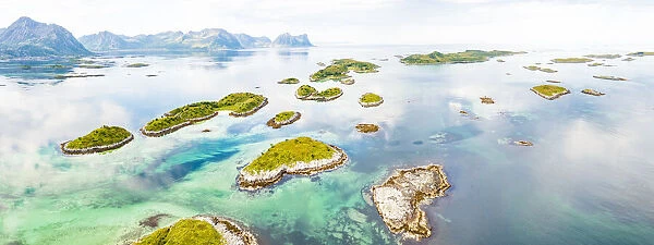 Aerial view of Bergsoyan Islands in the emerald transparent water of the fjord, Senja