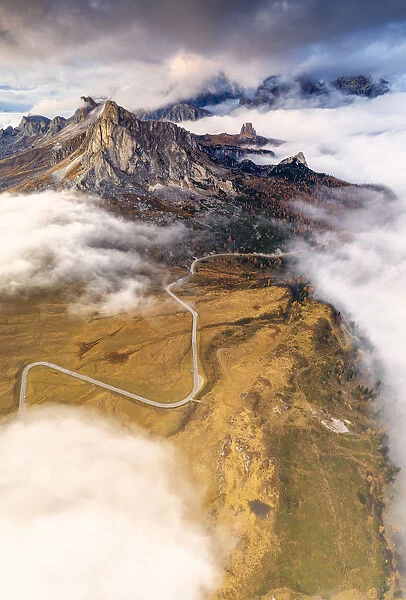 Aerial view by drone of Giau Pass, Ra Gusela and Cinque Torri in the mist of autumn