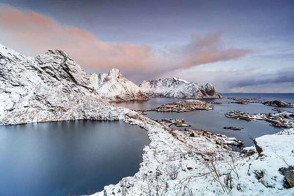 Aerial view of frozen lake Reinevatnet, Reine Bay and Olstind mountain covered with snow at dawn, Lofoten Islands, Norway, Scandinavia, Europe