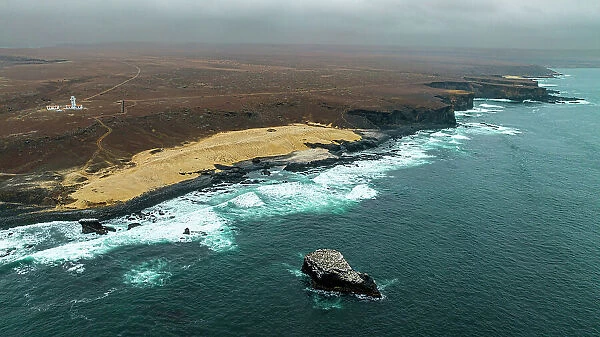 Aerial of the wild coastline with basalt pools on the Atlantic coastline, Dombe Grande, Namibre, Angola, Africa