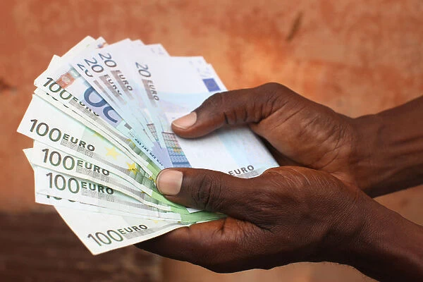 African holding Euros, Lome, Togo, West Africa, Africa