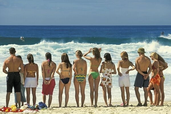 Attractive young people in swim wear lined up for a photo on Sydneys iconic Bondi Beach in the Eastern Suburbs, Bondi, New South Wales