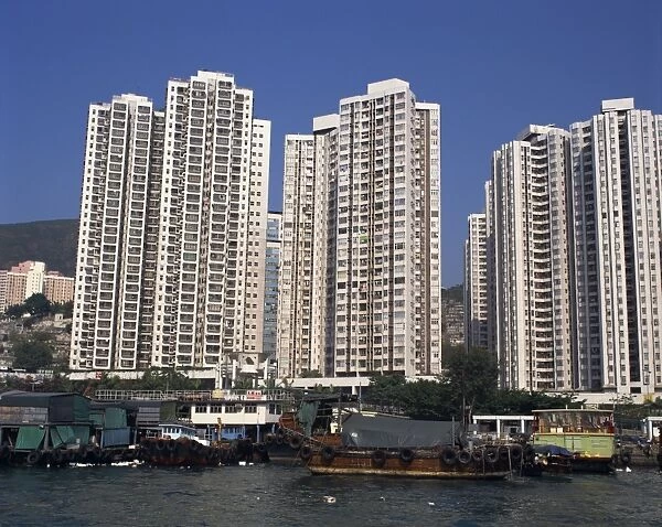 Boats in the harbour and new high rise apartment blocks for people who lived in sampans