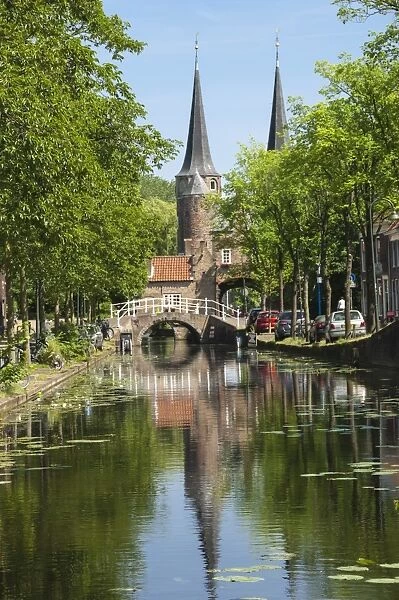 Canal scene with bridge, 16th century East Port Gate Towers, Delft, Holland, Europe