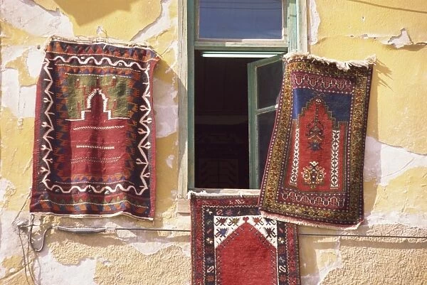 Carpets hanging on a wall for sale in Beysehir