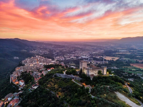 Cityscape of Narni at sunrise, with the fortress at the front and the old town beyond