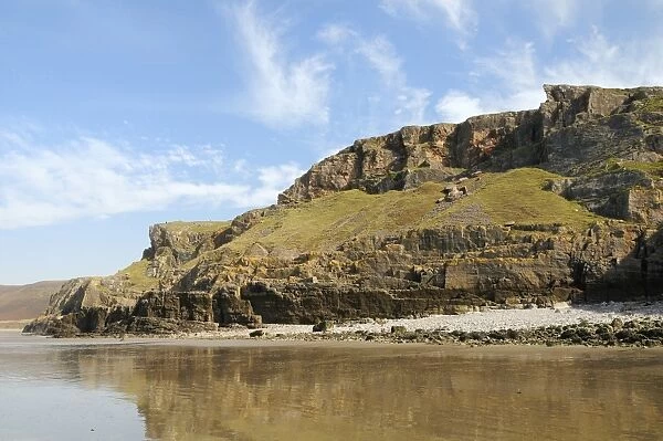 Coastal cliffs at Rhossili, viewed from below at low tide, The Gower peninsula, Wales, United Kingdom, Europe