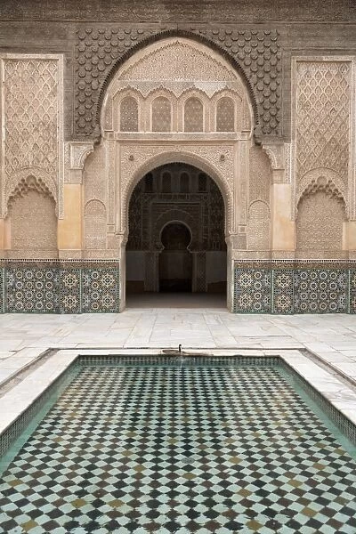 Courtyard and pool with traditional Moroccan ornate doorway in the Ben Youssef Medersa, UNESCO World Heritage Site, Marrakech, Morocco, North Africa, Africa